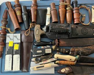 Many vintage waterfowl calls; vintage jackknives and hunting knives; Khyber knife with sheath; many hunting accessories.