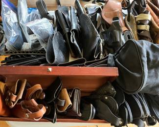 Numerous gun holsters and firearm accessories.