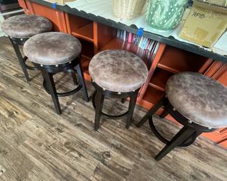 We have two sets of four leather top barstools