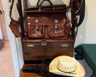 Hand made gun rack, tooled leather gun holsters and satchel