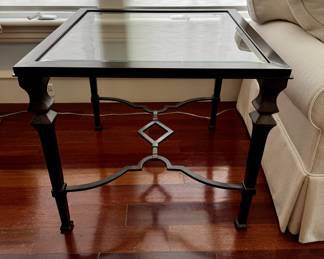 One of two metal and glass side tables