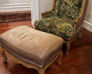 Upholstered wing chair with leather accents and coordinating wood carved leather ottoman