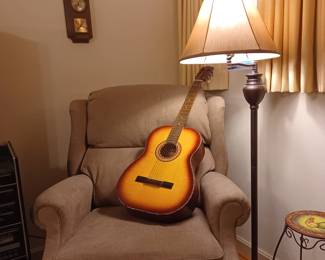 Vintage guitar and nice claw footed wing chair.