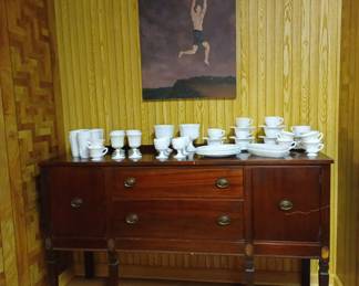 Indiana grape and cable milk glass on a mahogany 1940s sideboard
