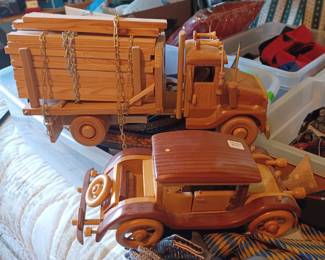 Two handmade wooden vehicles signed by craftsman.