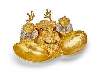 102
A French gilt-bronze encrier
Late 19th century
Cast with two shell-form bowls, a lidded scalloped well, and coral branches to support a pen, fitted with three lidded glass bottles and a seal with a turtle-form finial
4" H x 10" W x 8" D
Estimate: $700 - $900
