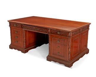 312
A Victorian-style carved mahogany pedestal desk
20th century
The desk with carved foliate and acanthus leaf motifs and egg and dart trim throughout, featuring opposed pull-out writing surfaces above three upper drawers, the middle with accessory trays, above three drawers to the left side and two drawers and a filing cabinet to the right, each drawer interior with later moiré lining
30.5" H x 72" W x 38.5" D
Estimate: $800 - $1,200