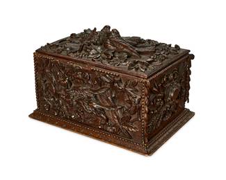 344
A Black Forest carved wood table box
19th century
With hinged lid, revealing a later leather-lined interior, the exterior carved with a bird figure to lid, hunting dogs to body, and foliate borders
10" H x 14.5" W x 10" D
Estimate: $300 - $500
