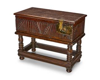 358
A William & Mary-style carved oak Bible box
20th century
The metal-mounted box with fan and rib carvings and a later lock on the right front edge, raised on a stand with four turned legs joined by stretchers
Overall: 17" H x 21" W x 10" D
Estimate: $300 - $500