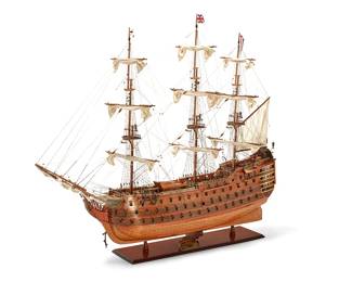94
An Old Modern Handicrafts model of HMS Victory
Late 20th century
With metal stand: HMS Victory / 1805
The wood model with canvas sails
60" H x 83" W x 16" D approximately
Estimate: $300 - $500