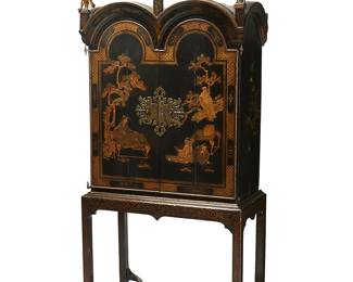 262
A Queen Anne-style black lacquered cabinet on stand
19th century with later elements
With three carved giltwood classical figures atop the arched structure, over two brass-mounted doors opening to reveal ten drawers, with gold lacquered chinoiserie decoration, raised on an associated gilt and ebonized wood stand
2 pieces
Cabinet: 63" H x 45" W x 21" D; Stand: 35" H x 42" W x 22" D
Estimate: $1,200 - $1,800