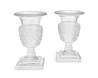 215
A pair of Lalique glass 'Versailles' vases
Late 20th century
Each etched: Lalique ® France [post-1978]; further numbered variously: 956 / 966
Each clear and frosted glass urn-form vase, on a square foot, raised on associated clear glass base
4 pieces
Each: 13.5" H x 9" Dia.
Estimate: $2,500 - $3,500