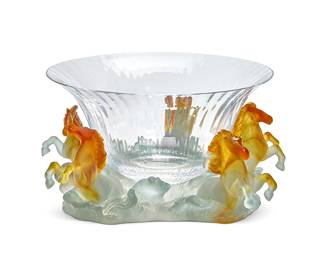 205
A Daum pâte-de-verre center bowl
Late 20th/early 21st century
The bowl and the base each signed and inscribed: Daum / France
The fluted clear glass bowl set in a pâte-de-verre base depicting five figures of horses emerging from the sea
Overall: 5.875" H x 13" Dia.
Estimate: $300 - $500