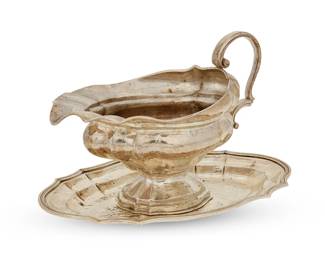 394
A Buccellati hammered sterling silver sauce boat and underplate
Late 20th/early 21st century
Marked: Buccellati / Italy / 925
Comprising a footed sauce boat with scrolled handle and an underplate with scalloped edge
2 pieces
Sauce boat: 6" H x 8.5" W x 4.75" D; Plate: 0.75" H x 9.75" W x 6.5" D
19.1 oz. troy approximately
Estimate: $500 - $700