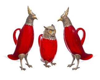 265
A group of Spanish silver-mounted ruby glass bird-form decanters
Mid/late 20th century
Each marked on metal mount: Spain
Comprising a pair of parcel-gilt silver-mounted glass eagle-form decanters, and a silver-mounted glass owl-form decanter with hinged lid and light orange eyes
3 pieces
The pair: 14.5" H; Owl: 11" H
Estimate: $1,500 - $2,000