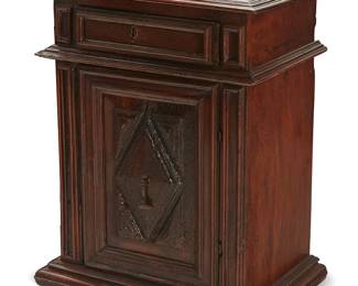 40
An Italian Renaissance carved walnut cabinet
17th century
The case with wrought-iron hardware, fitted with a single locking drawer above a hinged cabinet carved with a diamond pattern, opening to reveal a single shelf with later moiré lining
36" H x 27" W x 19" D
Estimate: $800 - $1,200