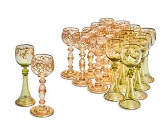 346
Two sets of Bohemian gilt-heightened glass cordials
Late 19th/early 20th century
Comprising a set of nine 8" gilt-decorated green glass tall cordials with grapevine decoration on flared stems, and a set of ten 7.75" gilt-decorated amber glass cordials, with knobbed stems
19 pieces
Estimate: $200 - $300