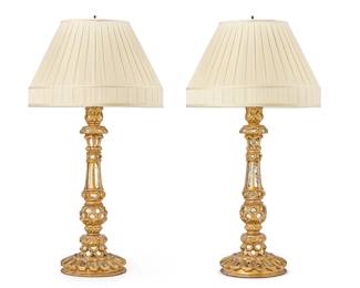 348
A pair of Spanish Baroque-style carved giltwood table lamps
20th century
Each bearing paper label for Carlos de la Puente Antiques
Each two-light lamp inset with small mirrors, surmounted by a pleated fabric shade, electrified
2 pieces
Each lamp: 34" H x 9.25" Dia.; Each shade: 11.75" H x 18.5" Dia.
Estimate: $500 - $700