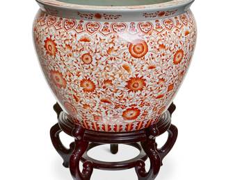 140
A Chinese porcelain fish bowl
20th century
Stamped to underside: UW / 1897
With red scrolling foliate decoration and painted to the interior with fishes, raised on a carved hardwood stand
Porcelain: 13.5" H x 17.5" Dia.; Stand: 8.25" H x 15" Dia.
Estimate: $300 - $500