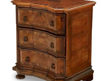 67
An Italian Baroque-style inlaid walnut commodino
Mid-19th century
With three drawers and brass hardware, the uppermost with locking mechanism, each drawer interior with later moiré lining, raised on bun feet
30.5" H x 26" W x 19" D
Estimate: $400 - $600