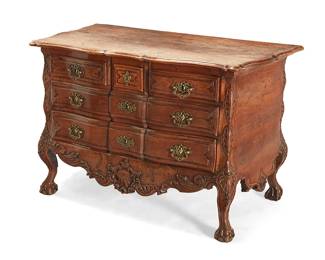 71
A Louis XV carved walnut commode
Mid-18th century
The top of the arc-en-arbalète outline above three short and two long drawers with later replaced pulls and escutcheons, with shell and foliate apron below, raised on cabriole legs ending in ball and claw feet
34" H x 51" W x 27.5" D
Estimate: $2,000 - $3,000