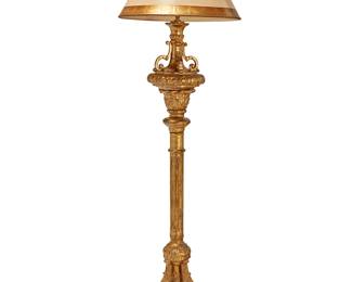 84
A Baroque-style carved giltwood floor lamp
20th century
The two-light lamp with fluted standard raised on four legs set on a tiered rounded base, surmounted by a paper shade, electrified
Overall: 71" H; Shade: 12" H x 22.25" Dia.
Estimate: $300 - $500