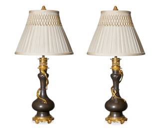 106
A pair of Chinese gilt-metal-mounted bronze table lamps
Late 20th century
Each single-light baluster-form vessel in the form of an oil lamp, with applied figures of dragons wrapped around the necks, each surmounted by a pleated fabric shade, electrified
2 pieces
Each lamp without harp or shade: 22.5" H x 6" Dia.; Each shade: 10.75" H x 14.5" Dia.
Estimate: $700 - $900