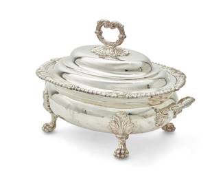 411
A Regency Sheffield silver-plated soup tureen
Early 19th century
Engraved with Scottish crest and motto
Of bombe oval form with bracket side handles, a gadrooned rim with shells and foliage at intervals, raised on four leaf-headed paw supports, the stepped domed lid with leaf capped scroll handle over foliage
12" H x 16" W x 11" D
Estimate: $800 - $1,200
