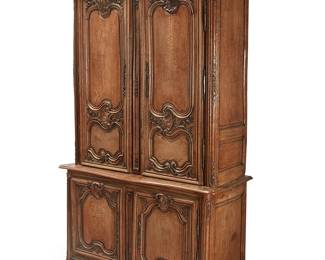 156
A Louis XV Provincial carved oak buffet a deux corps
18th century
Surmounted by a molded cornice, the upper section enclosed by a pair of paneled doors opening to reveal three later shelves; the lower section enclosed by a pair of doors opening to four locking drawers with brass butterfly-form pulls, all with shell and floral carved decorations
95" H x 55.5" W x 24" D
Estimate: $1,000 - $1,500