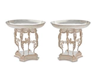 162
A pair of large English Etruscan-style silver-plated centerpieces
1929
With mark of Elkington & Co. and date mark; numbered: 29274
Retailed by J. Lyons & Co., Ltd., each with a shallow oval bowl resting on a stand with four winged sphinxes and lion monopodium supports, joined by scrolled stretchers centered by a pineapple finial, all on a coved square base
2 pieces
Each: 20" H x 22" W x 16" D
Estimate: $1,500 - $2,000