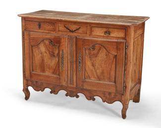 270
A Louis XV Provincial fruitwood buffet
19th century
The apron with inlaid vine-form accent centering two drawers, above two locking paneled cupboard doors, with carved vine top border, opening to reveal a single shelf
39.5" H x 52" W x 23" D
Estimate: $800 - $1,200