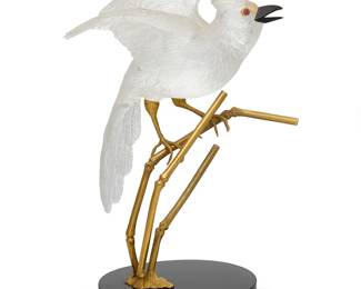 189
A Boucheron rock crystal jaybird sculpture
Mid-20th century
With French assay marks and maker's mark for Bondt; signed: Boucheron, No. 87417 / 250
The realistically carved jay with black onyx beak, cabochon ruby accent eyes, and gold feather crest and talons, perched on gold bamboo, the black onyx base with gold trim, mounted in 18K gold
Overall: 7.375" H x 4.75" W x 4.125" D
Estimate: $8,000 - $12,000