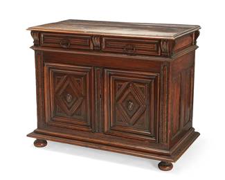 209
A French Renaissance-style carved walnut buffet
18th/19th century
With two drawers above two locking cupboard doors carved with diamond-form panels with masks, revealing a single shelf, each drawer and shelf interior with later moiré lining, raised on bun feet
39.25" H x 50" W x 26.5" D
Estimate: $1,500 - $2,000