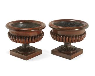 328
A matched pair of George IV carved mahogany wine coolers
One early 19th century, one later
In the manner of Gillows, each of circular form with gadrooned body and tapered fluted stem, on a square molded base, with metal liner
2 pieces
Each: 22" H x 28" Dia.
Estimate: $2,000 - $3,000
