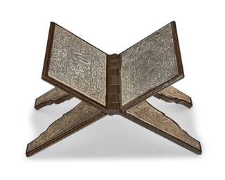 232
A silver-mounted wood folding Quran stand
20th century
With Arabic inscriptions to the .890 silver panels
Open: 10" H x 16" W x 7.5" D
Estimate: $200 - $300