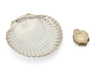 397
A Gorham sterling silver shell-form dish and set of butter pats
Early 20th century
Each marked for Gorham and sterling; shell numbered: 40617; pats numbered: 2720
Comprising a silver shell-form footed dish, personalized (1.75" H x 9.25" W x 9.25" D), and a set of gilt butter pats (Each: 0.125" H x 3.25" W x 2.5" D)
13 pieces
Total weight: 21.6 oz. troy approximately
Estimate: $400 - $600