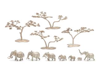 388
A collection of Patrick Mavros sterling silver table ornaments
Circa 2016; Harawe, Zimbabwe
Each marked for Patrick Mavros; each tree bearing personalized inscription
Comprising two pairs of 'Fari' acacia trees (Largest: 12" H x 19" Dia.; Smallest: 10" H x 18" Dia.) and a herd of African elephant figures including 'Ukari,' 'Rufaro,' 'Hash,' 'Ndlulamithi,' 'Chikwenya,' 'Jali,' and 'Kabakwe' (Tallest: 8.5" H; Shortest: 2" H), personalized
Total weight: 410 oz. troy approximately
Estimate: $20,000 - $30,000