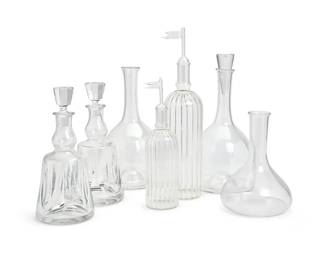240
A group of Contemporary glass decanters
Late 20th/early 21st century
Two with Saint-Louis stencil mark; three with Riedel stencil mark
Comprising a pair of Saint-Louis decanters with stoppers (11.5" H x 5.25" Dia.), a pair of large Riedel bulbous decanters, one with a stopper (With stopper: 14" H x 7" Dia.), a graduated pair of ribbed blown glass decanters with flag-form stoppers (Taller: 16.75" H x 4.5" Dia.), and a Riedel bulbous decanter (9.5" H x 7" Dia.)
7 pieces
Estimate: $400 - $600