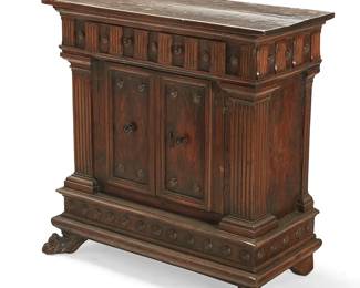 277
An Italian carved walnut credenza
18th century
Fitted with two drawers above a pair of locking cupboard doors opening to reveal a single shelf, flanked by fluted columnar and roundel accents to the corners, raised on paw feet
38" H x 37.5" W x 18" D
Estimate: $700 - $900