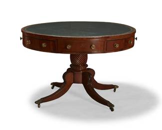 354
A George IV inlaid-mahogany drum table
Early 19th century
The circular crossbanded top inset with a green leather writing surface above three real and three faux frieze drawers, each drawer interior with later moiré lining, on a spirally turned pedestal and four splayed legs with acanthus leaf carvings ending in brass paw feet and casters
30" H x 43" Dia.
Estimate: $1,200 - $1,500