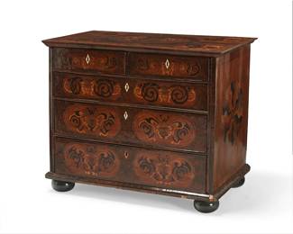 309
A William & Mary marquetry-inlaid oyster veneered chest
Late 17th century with later elements
Fitted with two short and three long inlaid floral and foliate drawers, with carved bone lock escutcheons, raised on compressed bun feet, each drawer later lined with moiré fabric
32" H x 39" W x 23" D
Estimate: $1,500 - $2,000