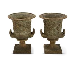 76
A pair of Neoclassical-style patinated bronze urns
19th century
Each of campana form, cast with ribbon tied swags and trophies, flanked by handles and raised on a square base
2 pieces
Each: 23" H x 17" Dia.
Estimate: $600 - $800
