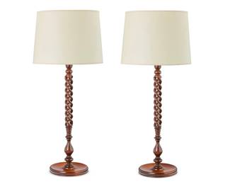 351
A pair of barley twist turned wood table lamps
Late 20th/21st century
The single-light lamps, each with open carved barley twist standard over a circular foot, surmounted by a paper shade, electrified
2 pieces
Overall: 36" H; Height of wood base: 26.5" H
Estimate: $150 - $250