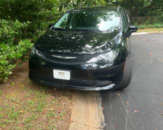 Please park two wheels in grass and two on pavement.
