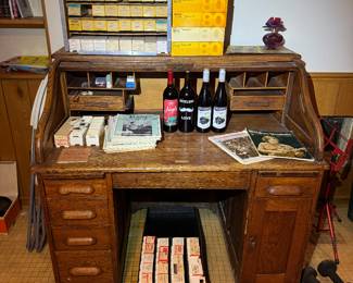 Rolltop desk, wine, slides (basement main room)
