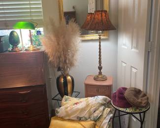 Collection of misc items. Small chest (2 drawer), Lamp, Wall mirror, Fun table, King Comforter, Pillow, hats, Glass top table (glass cracked) and floral decor.