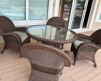#2 - $600 - All weather wicker brown table 52"Dx31T & 4 armchairs 32x28x38 - nesting under table - very good condition 
