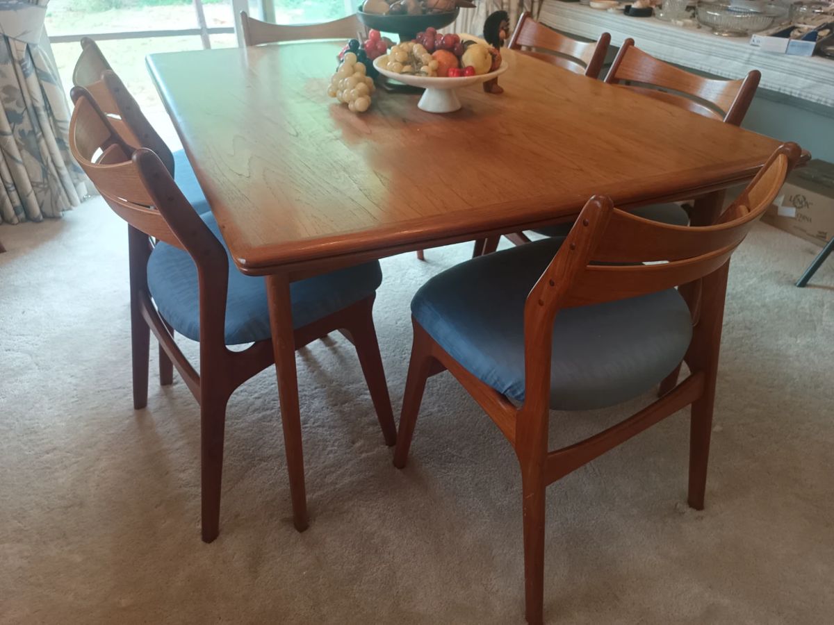 Teak table with extending leaves and 8 chairs.