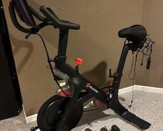 Peloton Bike, model #PLTN-RB1VQ-2 and mens and womens Peloton shoes.
