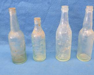 Lot 69. Four old beer bottles: